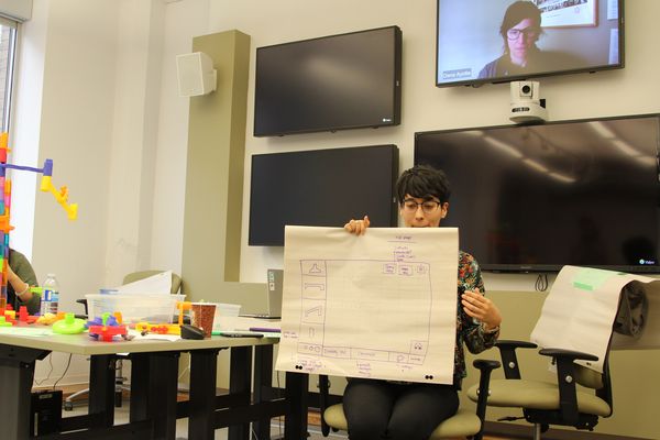 An image of a Create-a-Thon participant describing their group's design.